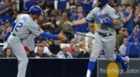 Los Angeles Dodgers third base coach Dino Ebel congratulates Chris Taylor after a home run