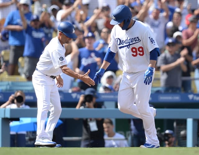 Los Angeles Dodgers third base coach Dino Ebel congratulates Hyun-Jin Ryu after his home run