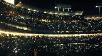 Fans hold up their cellphones during a concert at Dodger Stadium