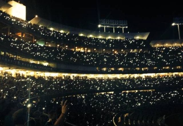 Fans hold up their cellphones during a concert at Dodger Stadium