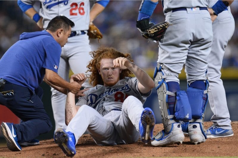Los Angeles Dodgers trainer helps Dustin May after he was hit in the head by a line drive