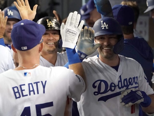 Los Angeles Dodgers teammates Matt Beaty, Kiké Hernandez and A.J. Pollock celebrate in the dugout