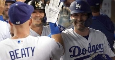 Los Angeles Dodgers teammates Matt Beaty, Kiké Hernandez and A.J. Pollock celebrate in the dugout