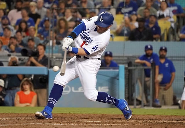 Los Angeles Dodgers infielder Max Muncy hits an RBI single against the Colorado Rockies