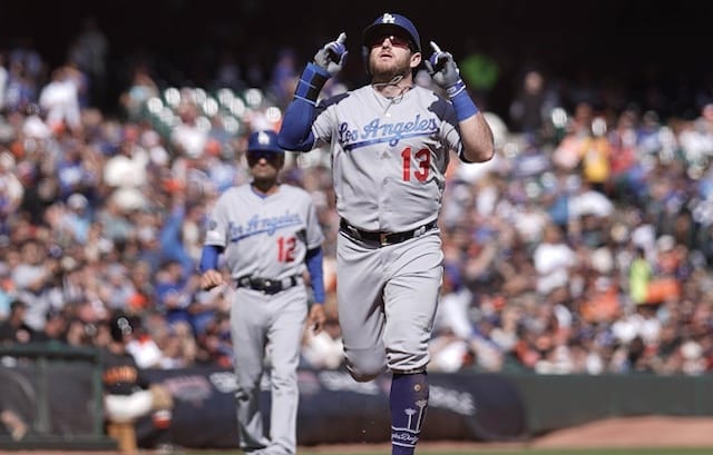 Los Angeles Dodgers third base coach Dino Ebel watches Max Muncy celebrate after a home run