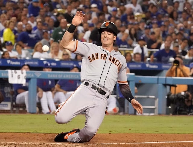 San Francisco Giants outfielder Mike Yastrzemski scores a run against the Los Angeles Dodgers