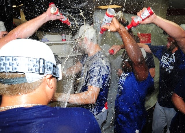 Rich Hill, Clayton Kershaw and the Los Angeles Dodgers celebrate after clinching the NL West during the 2019 season