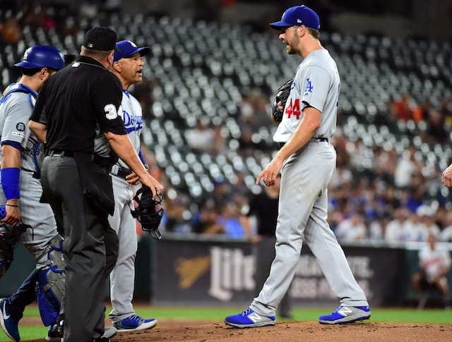 Los Angeles Dodgers manager Dave Roberts checks on Rich Hill during a start against the Baltimore Orioles