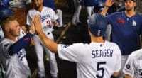 Corey Seager is congratulated by Los Angeles Dodgers teammates Rich Hill, Gavin Lux and Kristopher Negrón
