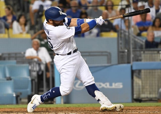 Los Angeles Dodgers catcher Russell Martin hits a home run against the Colorado Rockies