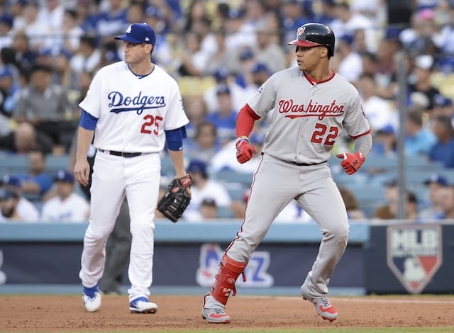 Los Angeles Dodgers infielder David Freese looks on after Washington Nationals infielder Juan Soto hit a single in Game 1 of the 2019 NLDS