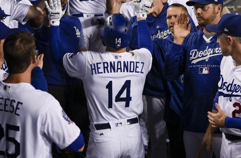 Los Angeles Dodgers teammates David Freese, Kiké Hernandez, Rich Hill and Chase Utley celebrate in the dugout
