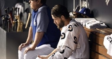 Los Angeles Dodgers pitching coach Rick Honeycutt with Clayton Kershaw in the dugout during Game 2 of the 2019 NLDS