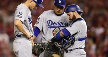 Los Angeles Dodgers teammates Russell Martin, Hyun-Jin Ryu and Corey Seager go over signs during a mound visit