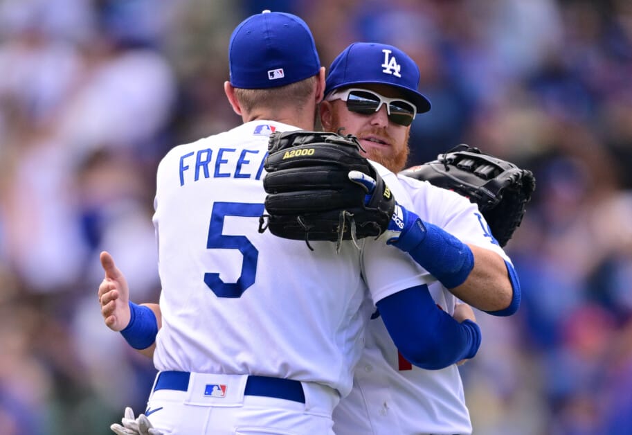 Los Angeles Dodgers' Justin Turner, right, smiles at Freddie Freeman after  he hit a sacrifice f …
