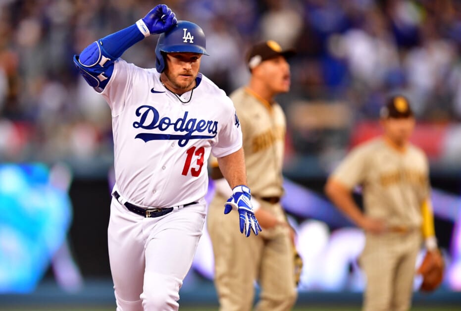 Los Angeles Dodgers' Max Muncy fixes his cap while wearing a new